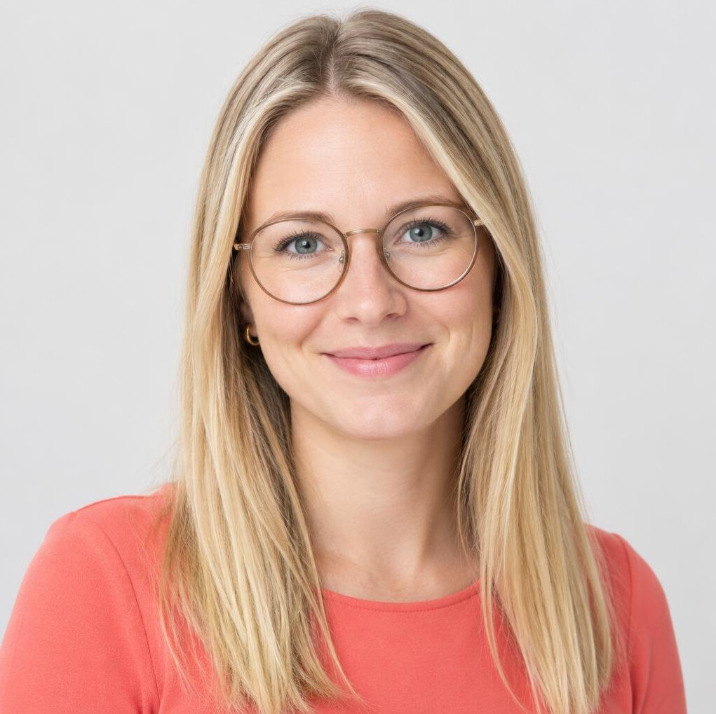 Studio portrait of a young female editor with glasses
