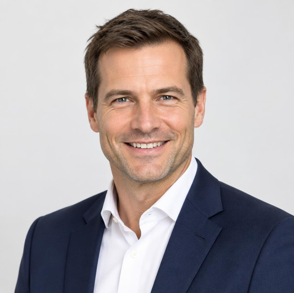 Studio portrait of a male journalist in a navy blazer
