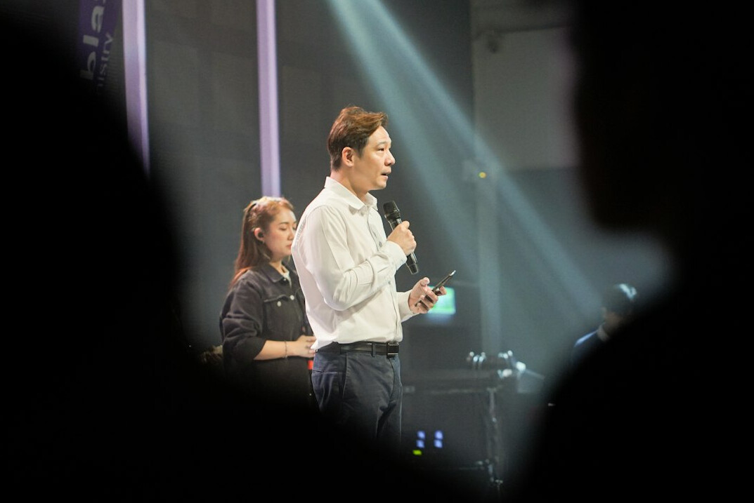 tv moderator smiling on stage