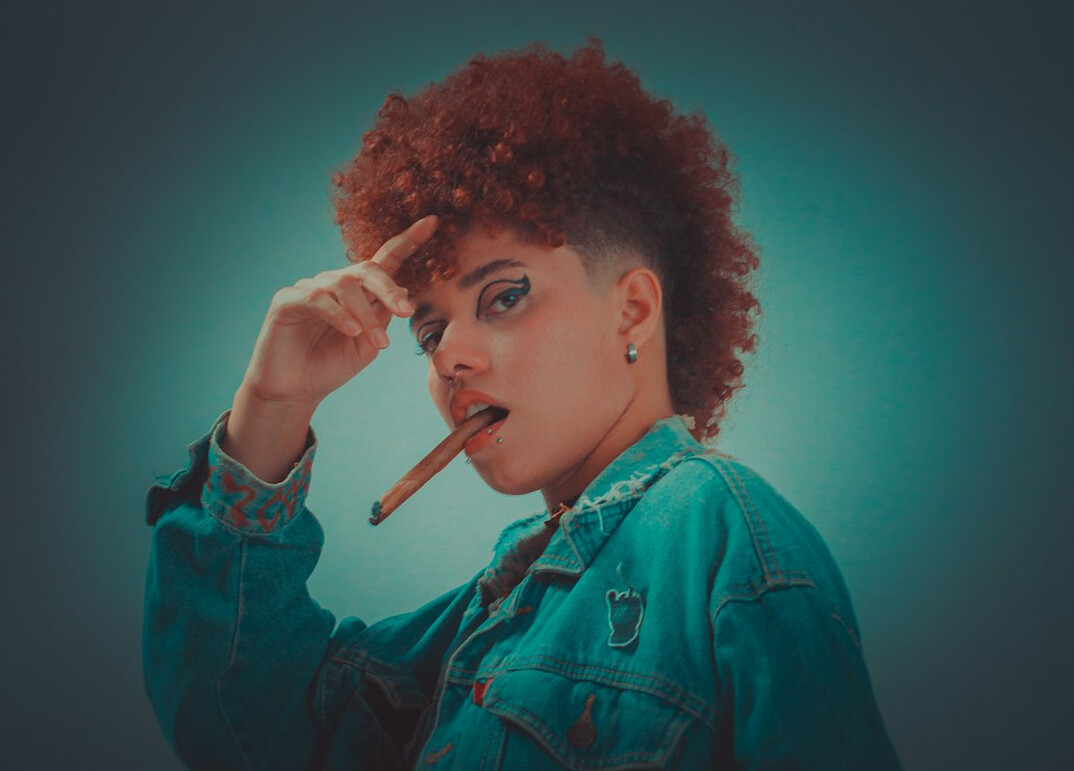 Studio portrait of a female journalist with curly hair